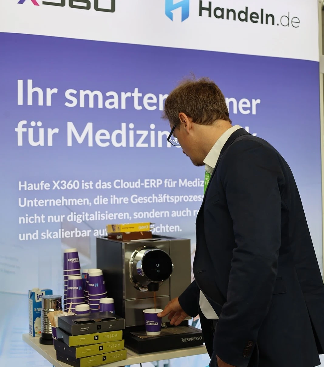 Mann zapft Kaffee an Nespresso-Maschine am Messestand